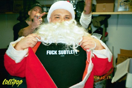 Eric Corbin wearing his Fuck Subtlety shirt beneath his Santa suit and Da' Core's 9th annual X-mas bash.